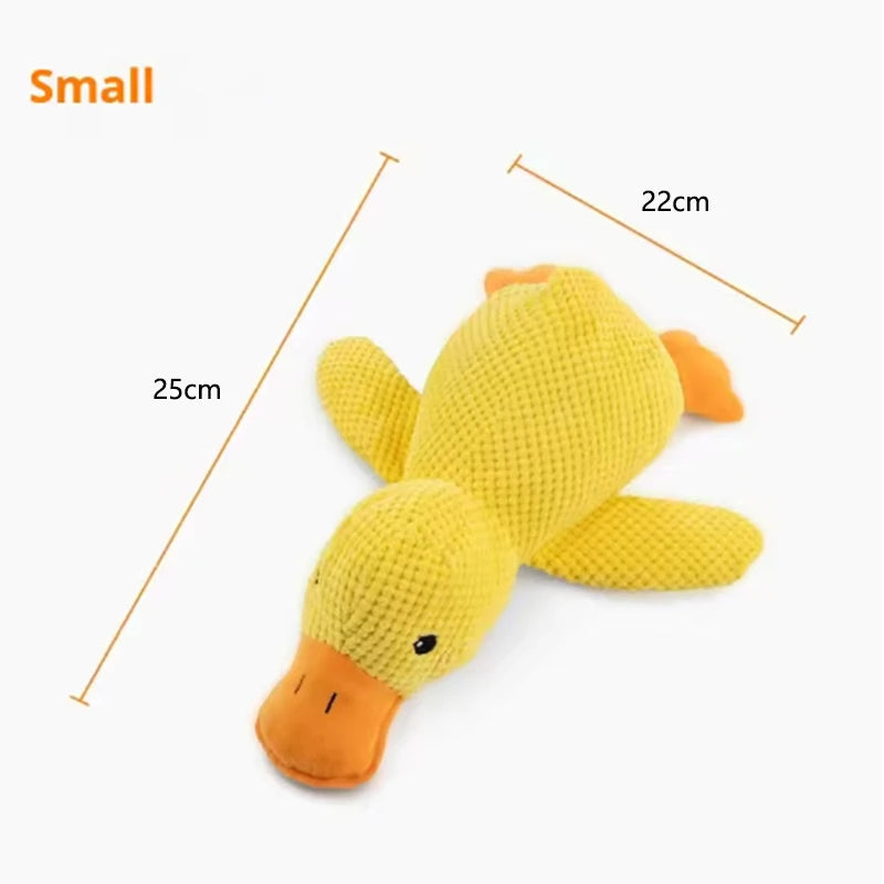 Dog sleeping with a dog hug duck toys to relieve boredom of little yellow duck pet